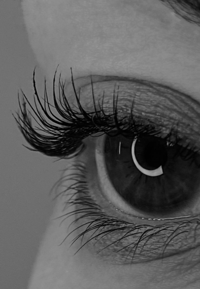 Close-up of an eye with long, curled eyelash extensions