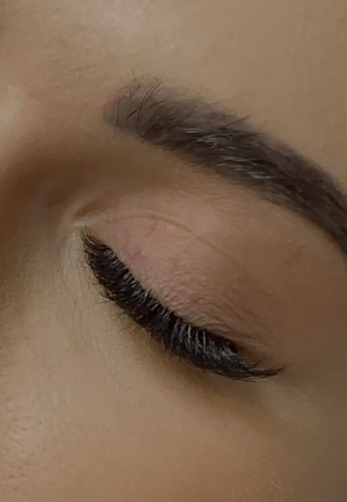 Close-up of a perfectly groomed eyebrow and eyelash extensions